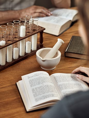 Homeopathy student reading a book